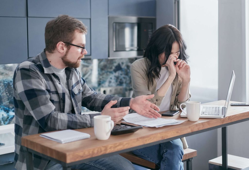 A couple sit at a table trying to reach an agreement but struggling, If your Couples Therapy in Boca Raton, FL is not working it may be time to reevaluate.